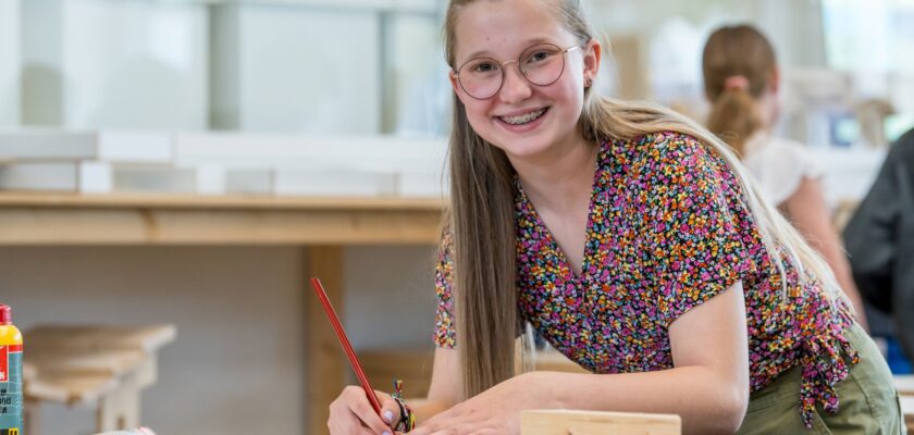 BWI leerling kijkt op van haar werk