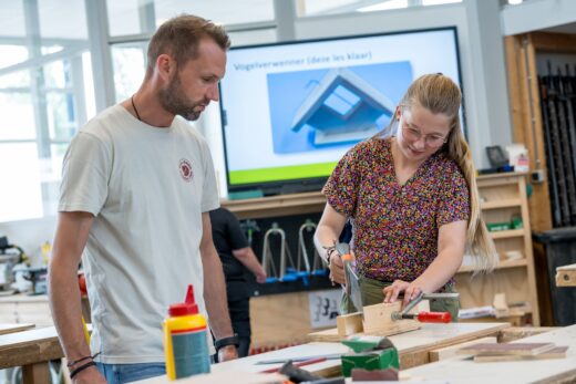 Docent helpt leerlingen bij BWI